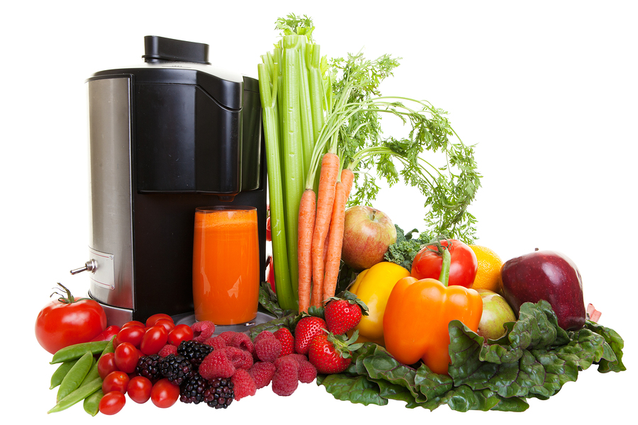 A Juicer surrounded by healthy fruits and vegetables, isolated o